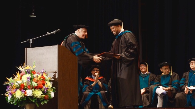 Dr. John P. Docherty, Chairman of the Board of Trustees of the Medical University of the Americas and the Saba University of Medicine presents Hon. Mark Brantley, Deputy Premier of Nevis, with an honorary Doctor of Laws degree at the schools commencement ceremony, at the Veterans Memorial Auditorium in Rhode Island, USA on June 03, 2017